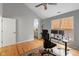 Bright bedroom features a vaulted ceiling, hardwood floors, a ceiling fan, and a view of the en suite bathroom at 2075 Rhettsbury St, Carmel, IN 46032