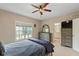 Comfortable bedroom with a large window, dresser, and a glimpse into the en-suite bathroom at 2075 Rhettsbury St, Carmel, IN 46032