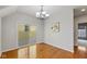 Bright dining room featuring hardwood floors, modern chandelier and sliding glass door leading to the backyard at 2075 Rhettsbury St, Carmel, IN 46032
