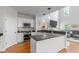 Bright kitchen featuring stainless steel appliances, dark countertop and open to the living room at 2075 Rhettsbury St, Carmel, IN 46032