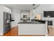 Modern kitchen with stainless steel appliances, dark countertops, white cabinetry, and open layout at 2075 Rhettsbury St, Carmel, IN 46032