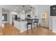 Modern kitchen with stainless steel appliances, breakfast bar, and hardwood floors at 2075 Rhettsbury St, Carmel, IN 46032