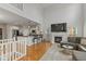 Open-concept living space with fireplace, kitchen, hardwood floors, and comfortable furniture at 2075 Rhettsbury St, Carmel, IN 46032