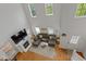High-angle view of living room featuring a large sectional, fireplace, TV, windows, and hardwood floors at 2075 Rhettsbury St, Carmel, IN 46032