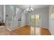 Open living space with hardwood floors, staircase, and sliding glass door leading to outdoor at 2075 Rhettsbury St, Carmel, IN 46032