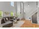 Bright living room with vaulted ceiling, hardwood floors, and comfortable sectional seating at 2075 Rhettsbury St, Carmel, IN 46032