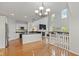 Open concept living room featuring a fireplace, modern kitchen, and abundant natural light at 2075 Rhettsbury St, Carmel, IN 46032