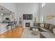 Spacious living area with modern furniture, fireplace, and kitchen with breakfast bar at 2075 Rhettsbury St, Carmel, IN 46032