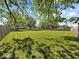 Spacious backyard featuring a large lawn area, bordered by a wood fence and mature shade trees at 2233 S Miller Ave, Shelbyville, IN 46176