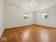 Empty bedroom with hardwood floors, two windows, and a neutral color scheme at 2233 S Miller Ave, Shelbyville, IN 46176