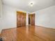 Empty bedroom with hardwood floors, natural light, and double closets at 2233 S Miller Ave, Shelbyville, IN 46176