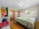 Bedroom featuring hardwood floors, natural light, closet, and a green accent wall at 2233 S Miller Ave, Shelbyville, IN 46176
