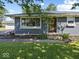 Home exterior featuring diamond pane windows, a well-kept lawn, and manicured landscaping at 2233 S Miller Ave, Shelbyville, IN 46176
