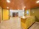 Open kitchen featuring a breakfast bar, wood ceiling, and view to the living room at 2233 S Miller Ave, Shelbyville, IN 46176
