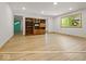 Bright living room with wood floors, built-in shelving, and a large window letting in natural light at 2233 S Miller Ave, Shelbyville, IN 46176