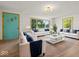 Bright living room featuring lots of seating, large windows, and wood-look floors at 2233 S Miller Ave, Shelbyville, IN 46176