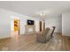 Open living room featuring a fireplace, wood-look floors, and lots of natural light at 2233 S Miller Ave, Shelbyville, IN 46176