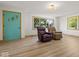 Bright living room featuring lots of seating, large windows, and wood-look floors at 2233 S Miller Ave, Shelbyville, IN 46176