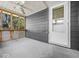 Enclosed porch featuring a ceiling fan, door to the outside, and window views at 2233 S Miller Ave, Shelbyville, IN 46176