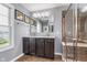 This bathroom features a double sink vanity with granite countertops, a large mirror and a walk-in shower at 2436 Gwinnett St, Carmel, IN 46032