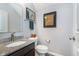 Powder room featuring granite vanity top, framed art and brushed bronze faucet at 2436 Gwinnett St, Carmel, IN 46032