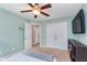 This bedroom features neutral paint, white trim, a ceiling fan and a double-door closet at 2436 Gwinnett St, Carmel, IN 46032