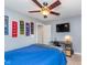 This bedroom features neutral paint, white trim, a ceiling fan, a television, and sports decor at 2436 Gwinnett St, Carmel, IN 46032
