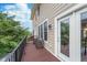 This outdoor deck features neutral siding, a wooden floor, and a view of nearby trees at 2436 Gwinnett St, Carmel, IN 46032