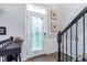 Welcoming foyer with decorative glass door and staircase with black iron railing at 2436 Gwinnett St, Carmel, IN 46032