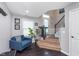 Cozy living space featuring a comfortable blue sofa and staircase at 2436 Gwinnett St, Carmel, IN 46032
