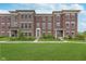 Beautiful brick townhome with well-manicured lawn and charming landscaping at 2436 Gwinnett St, Carmel, IN 46032