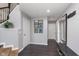Hallway with dark wood floors, white doors and access to other rooms at 2436 Gwinnett St, Carmel, IN 46032