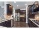 Elegant kitchen features stainless appliances, granite countertops, and dark wood cabinets at 2436 Gwinnett St, Carmel, IN 46032