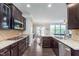 Open concept kitchen with stainless appliances, granite countertops and modern cabinets at 2436 Gwinnett St, Carmel, IN 46032