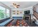 Inviting living room with fireplace, large windows, modern decor and ceiling fan at 2436 Gwinnett St, Carmel, IN 46032