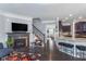 Open floorplan featuring fireplace, hardwood floors, kitchen access and modern decor at 2436 Gwinnett St, Carmel, IN 46032