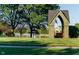 Covered park bench looking out on a scenic lake with a fountain and view of nearby neighborhood buildings at 2436 Gwinnett St, Carmel, IN 46032
