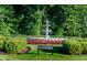 Beautiful water fountain surrounded by green bushes and red flowers in Chelmsford Circle at 2436 Gwinnett St, Carmel, IN 46032