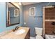 Stylish bathroom showcasing a granite vanity, framed mirror, and tiled shower with a decorative wood accent at 2519 N Boehning St, Indianapolis, IN 46219