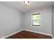 Bright, neutral bedroom with wood floors and a window with mini blinds at 2519 N Boehning St, Indianapolis, IN 46219