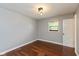 Simple bedroom with hardwood floors, a window, and a closet at 2519 N Boehning St, Indianapolis, IN 46219