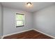 Neutral bedroom featuring hardwood floors, one window, and an electrical outlet at 2519 N Boehning St, Indianapolis, IN 46219