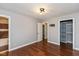 Bright bedroom with wood flooring, neutral walls, and entrances to closet and bathroom at 2519 N Boehning St, Indianapolis, IN 46219