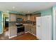 Charming kitchen featuring stainless steel appliances, granite countertops, and attractive mosaic backsplash at 2519 N Boehning St, Indianapolis, IN 46219
