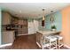 Open concept kitchen featuring a breakfast bar, stainless appliances and stylish fixtures at 2519 N Boehning St, Indianapolis, IN 46219
