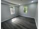 Bright bedroom with new gray floors and ample natural light from windows at 2911 E 35Th St, Indianapolis, IN 46218