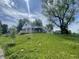 A charming home on a lush green lawn, surrounded by mature trees and a welcoming deck at 2911 E 35Th St, Indianapolis, IN 46218