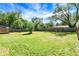 The huge fenced in backyard of this cute home features mature trees and a grassy lawn at 2936 N Gladstone Ave, Indianapolis, IN 46218
