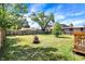 The huge fenced in backyard of this cute home features mature trees and a grassy lawn at 2936 N Gladstone Ave, Indianapolis, IN 46218