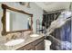 Bathroom with granite counters, double sinks, and an ornate framed mirror at 2936 N Gladstone Ave, Indianapolis, IN 46218